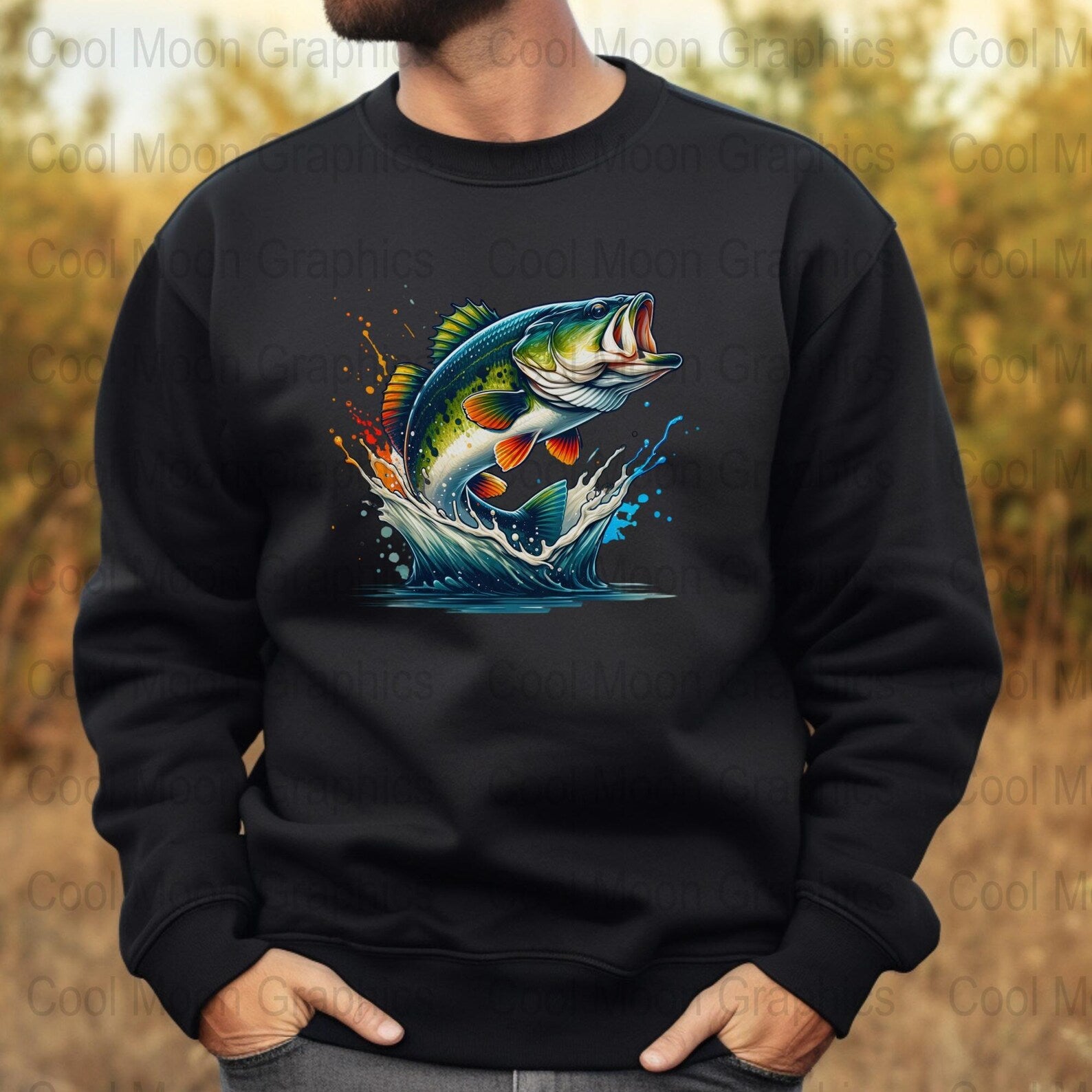 Black sweatshirt with a colorful largemouth bass graphic on a blurred nature background