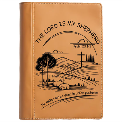 Brown leather journal cover with engraved landscape design and text "The Lord Is My Shepherd" on a white background