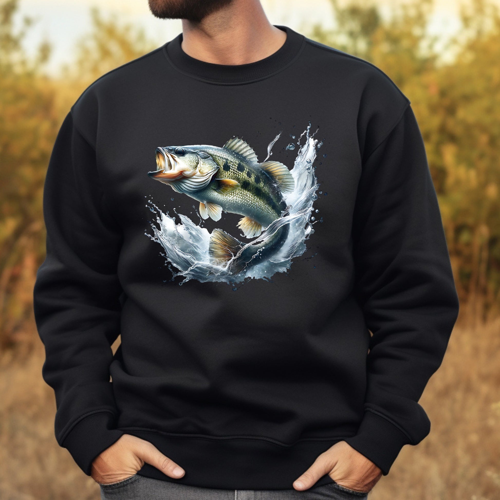 Black sweatshirt with a smallmouth bass fish graphic worn by a man, outdoors.