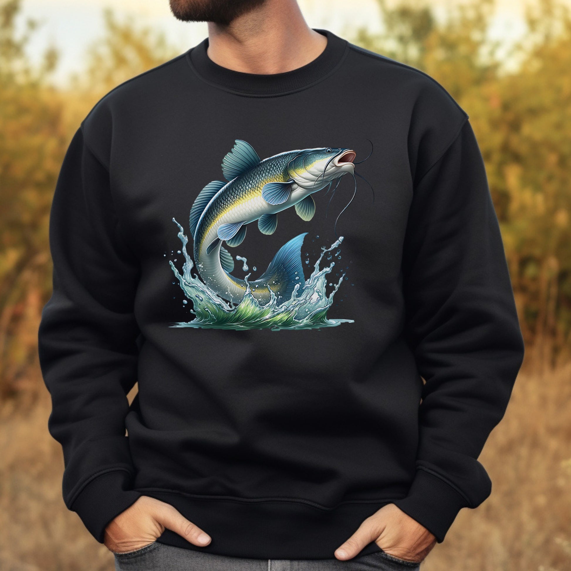 Black sweatshirt with a catfish graphic worn by a person, outdoors.