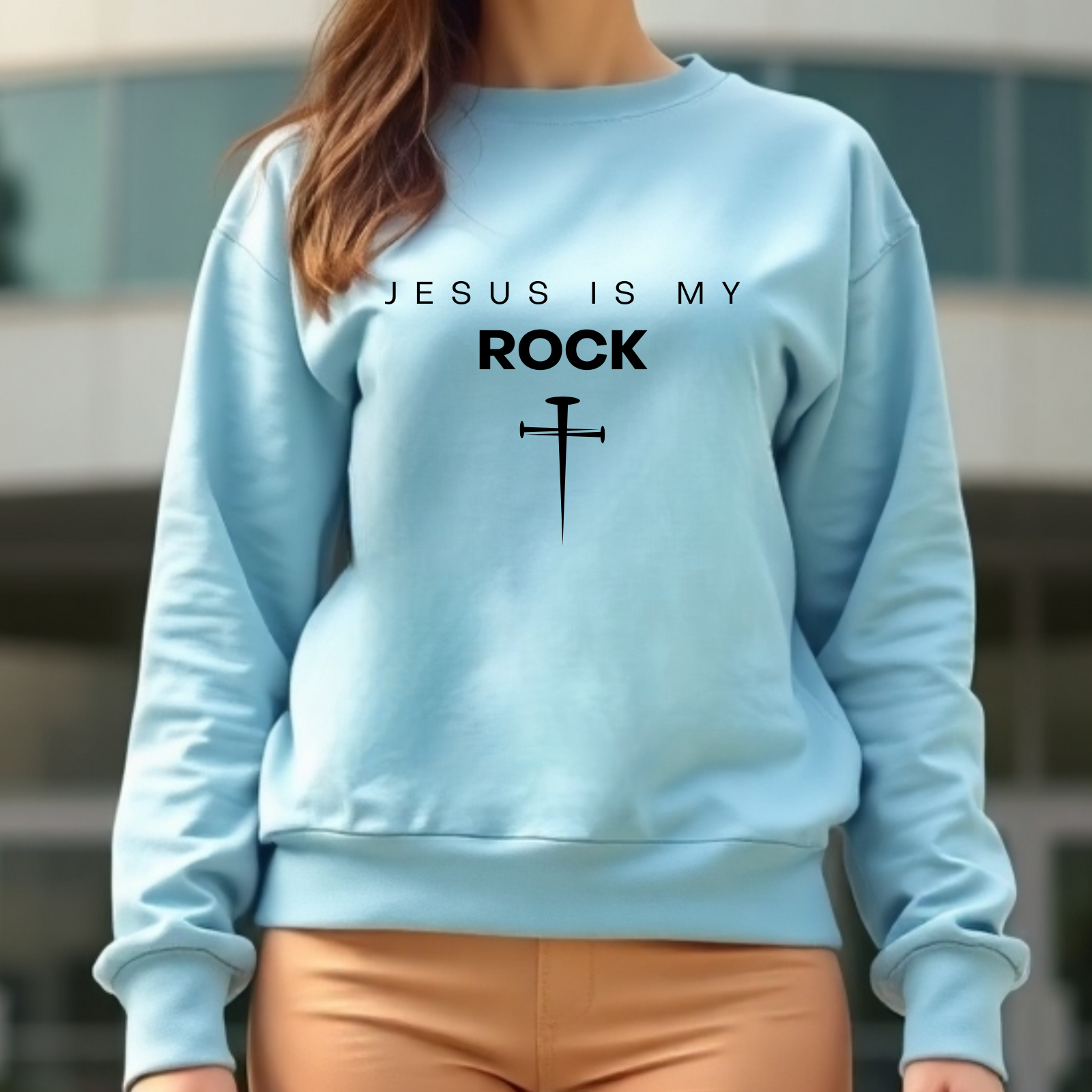 Jesus Is My Rock digital design on a woman’s blue sweatshirt.