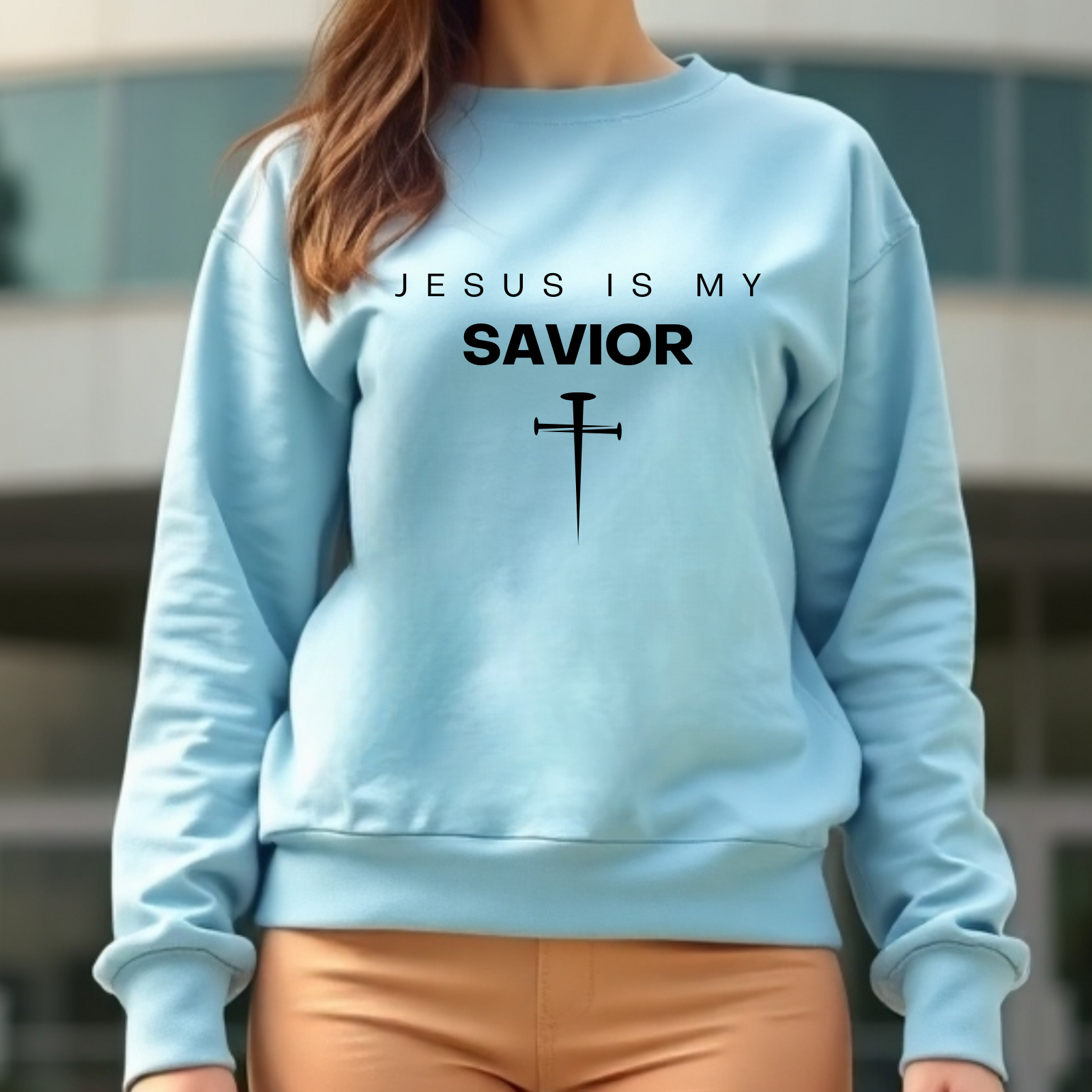 Jesus Is My Savior digital design on a woman’s blue sweatshirt.