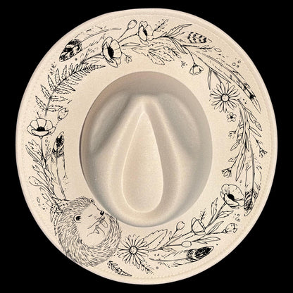 A sleeping hedgehog in a floral wreath shape for burning on wide brim hats