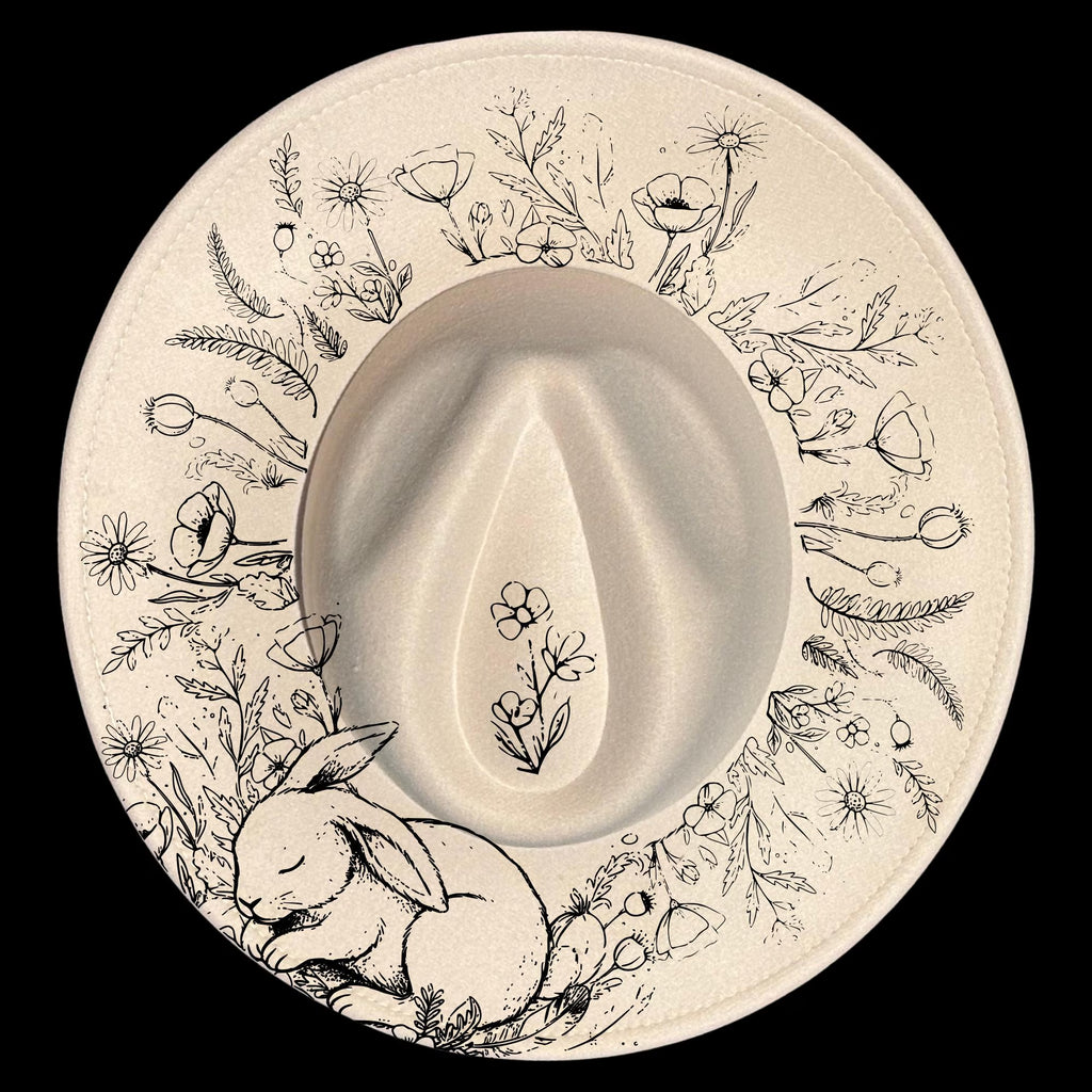 Wide brim hat with floral patterns and a sleeping rabbit on a black background