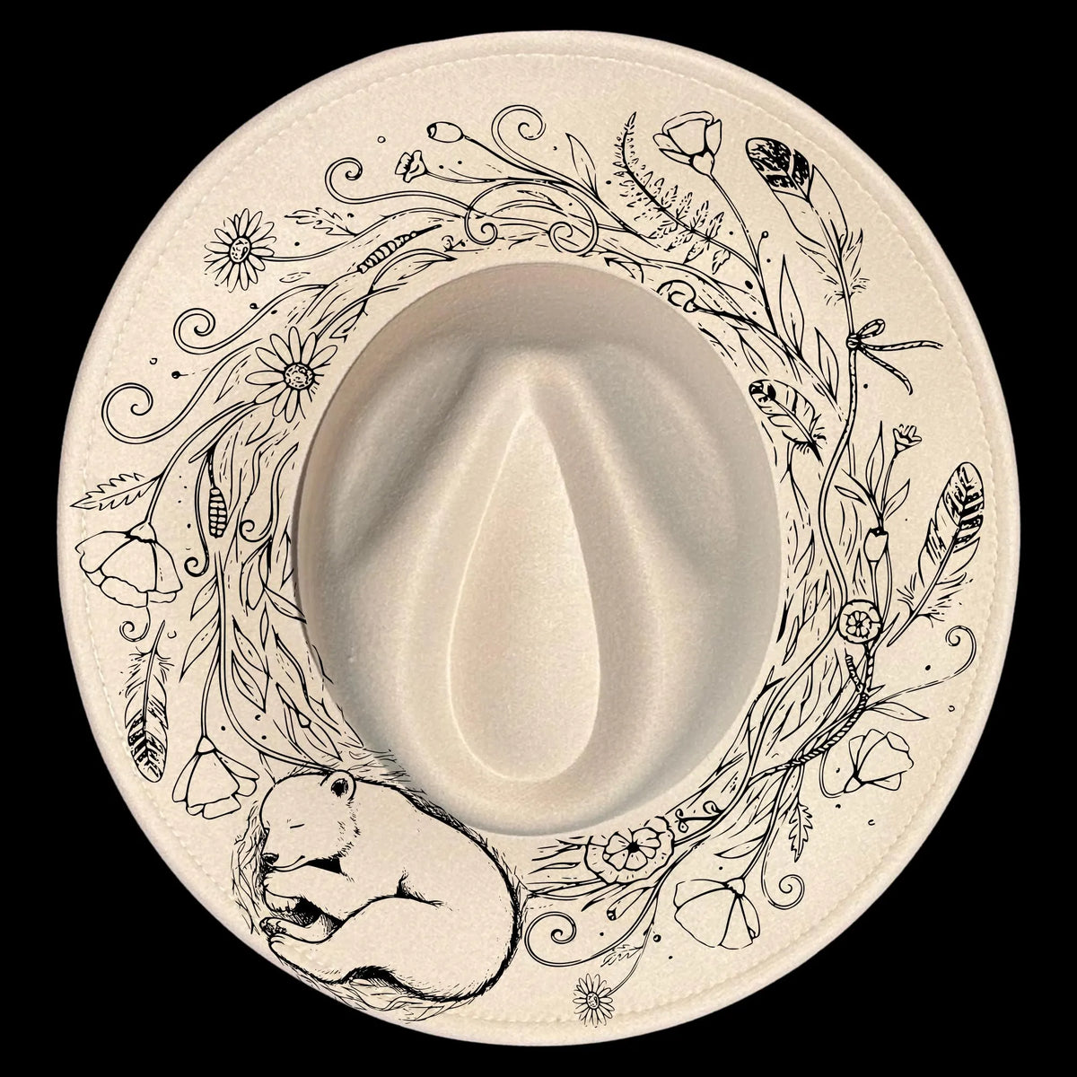 A wide brim hat with a bear and floral designs on a black background