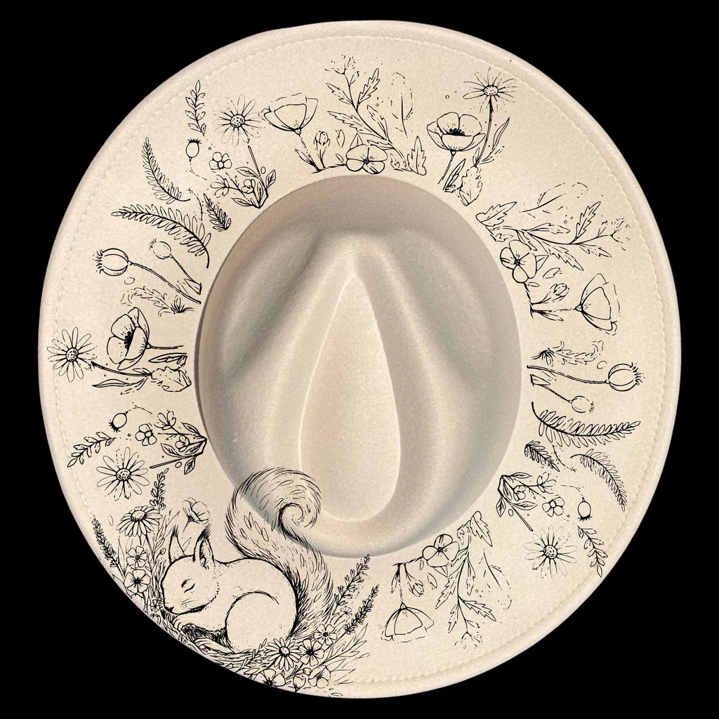 Wide brim hat with a floral design surrounded by line art of nature elements and a squirrel on a black background.