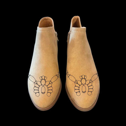 Squash Blossom boot burning design on a pair of shoes.