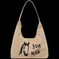 Leather bag with horse illustration and 'Stay Wild' text on a black background