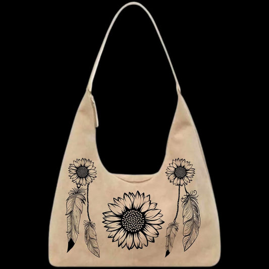 Beige leather bag with black sunflower and feather designs on a black background
