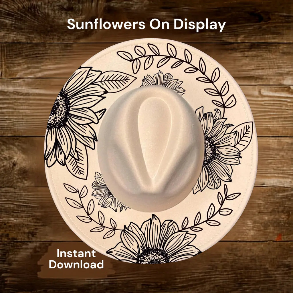 White cowboy hat with sunflower designs on a wooden background