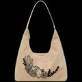 Leather tote bag with black floral and cactus design on a black background