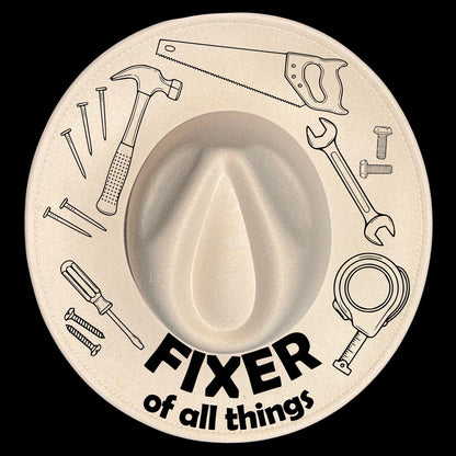 A wide brim hat with tool designs and the text 'Fixer of all things' on a black background.