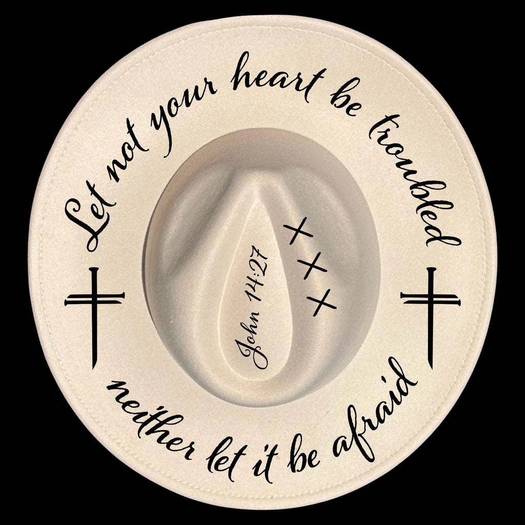 Decorative  religious text on a wide brim hat against a black background