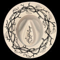 A vine wreath hat burning design on a wide brim hat