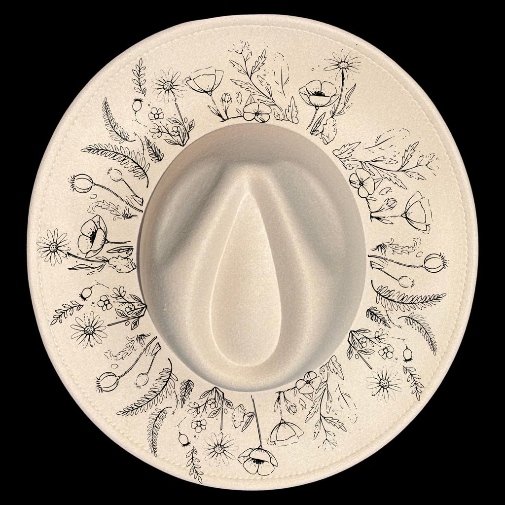 Floral patterns design burned on a wide brim hat on a black background