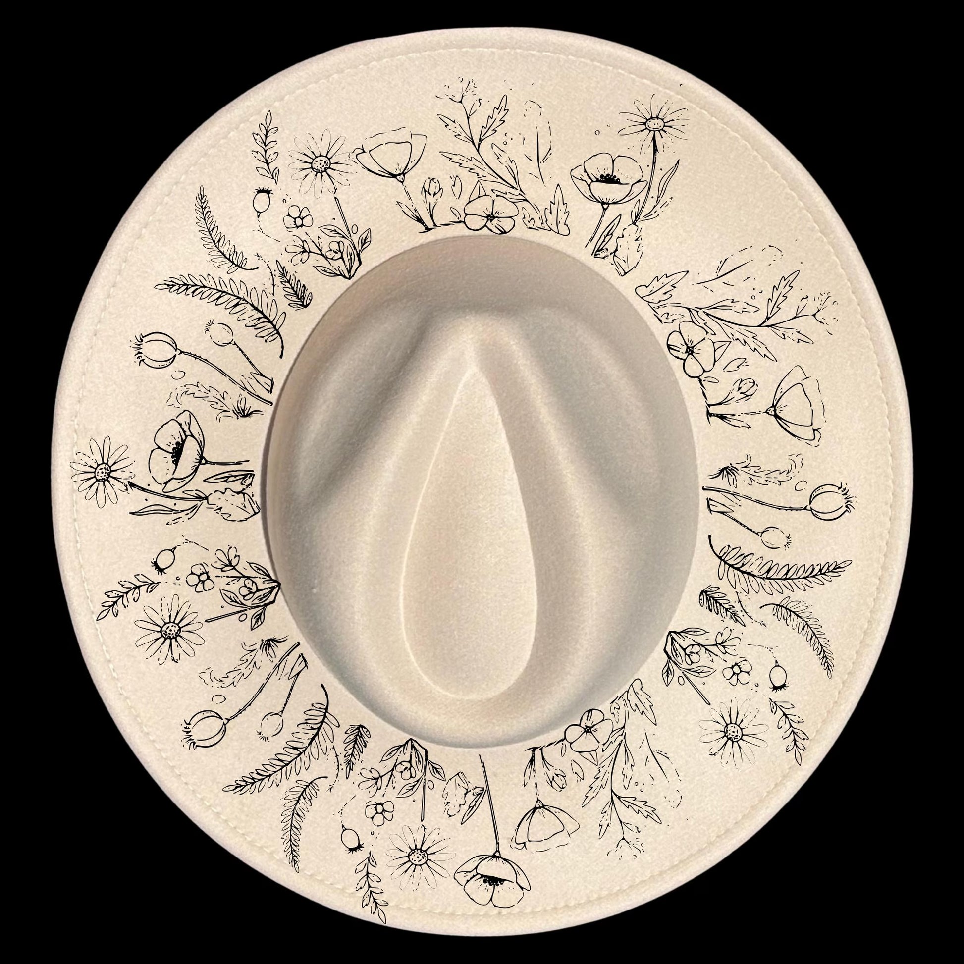 Floral patterns design burned on a wide brim hat on a black background