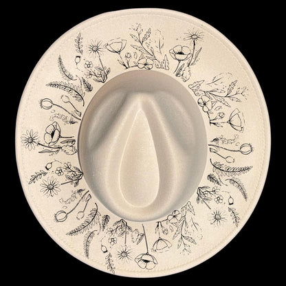 Floral patterns design burned on a wide brim hat on a black background