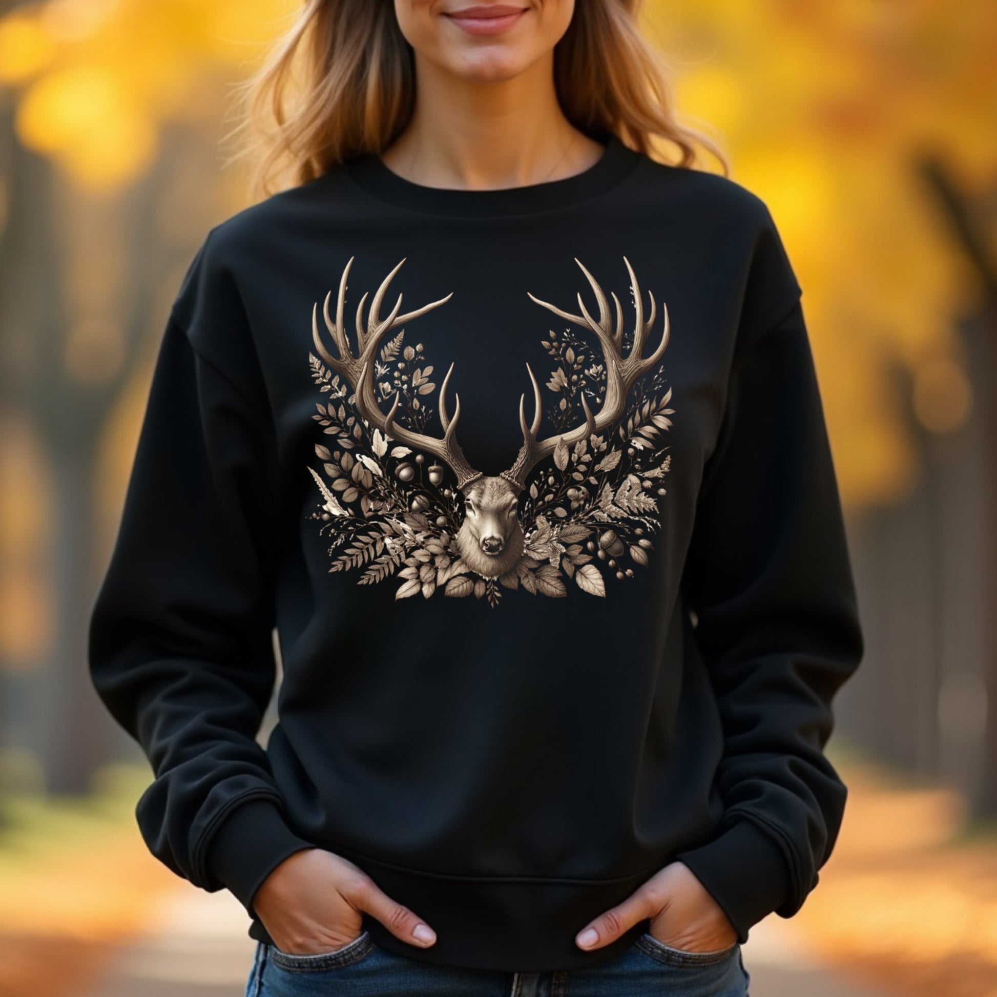 Woman wearing a black sweatshirt with a deer design in an autumn setting